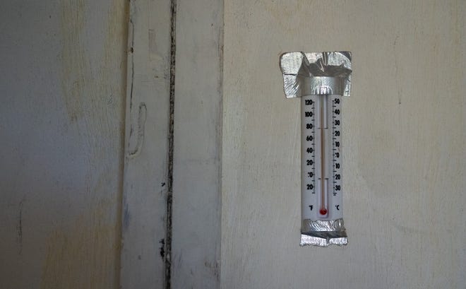 A thermometer reads near 115 degrees inside a mock prison cell set up near the south steps of the Texas State Capitol in Austin, July 18, 2023. Texas Prisons Community Advocates set the cell up to raise awareness surrounding prison conditions in Texas, particularly the lack of air conditioning.