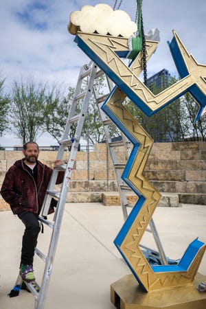 Artist Guadalupe Maravilla stands with his art installation, "Serpent of the Sun and the Moon," at Waterloo Park Wednesday, March 20, 2024. The installation explicitly incorporates Indigenous perspectives on the eclipse.