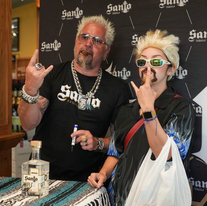 Valeria Chavira takes a photo with Guy Fieri at Twins Liquor at the Hancock Center on Thursday, March 28, 2024. Fieri came to Texas in support of his and Sammy Hagar’s Santo Spirits brand.