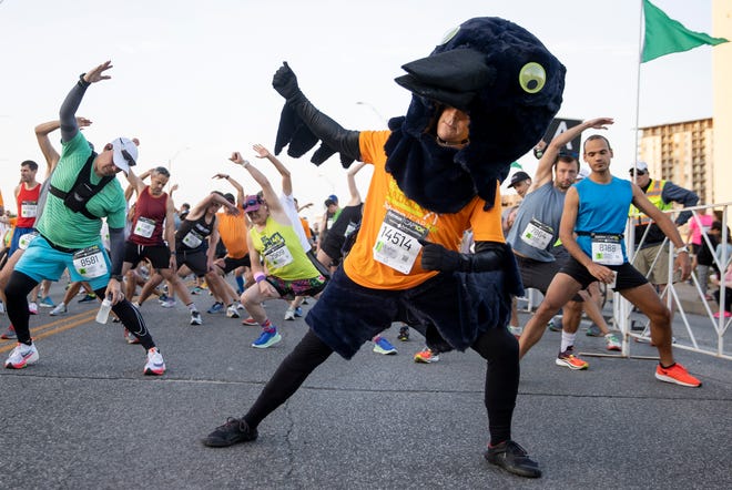 David Moreau, dressed as a grackle, warms up for the start of the Statesman Cap 10K on Sunday April 10, 2022.